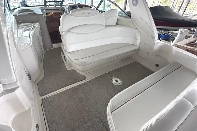 Slide: The Image of 2001 Sea Ray 340 Sundancer interior with white seating and carpeted flooring. - 4