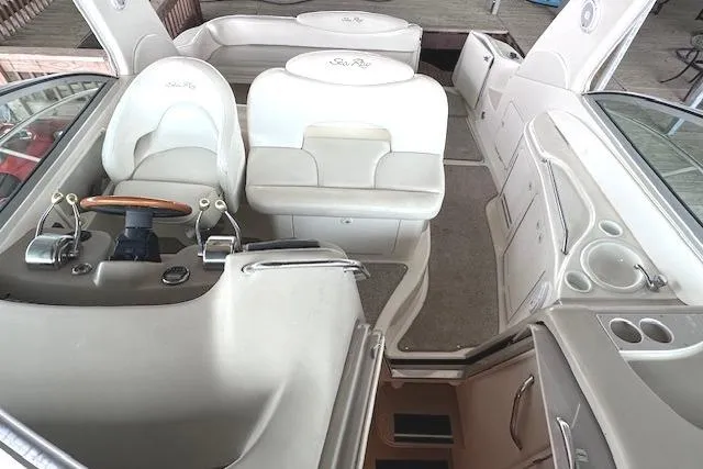 Slide: The Image of 2001 Sea Ray 340 Sundancer interior with helm, seating, and cabin entrance. - 8