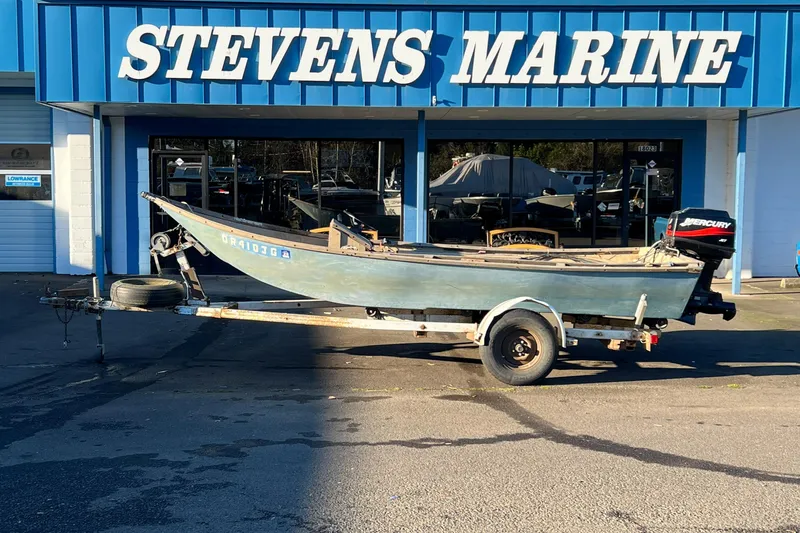 The Image of 1977 Homebuilt 16' wood boat on trailer outside Stevens Marine. - 1
