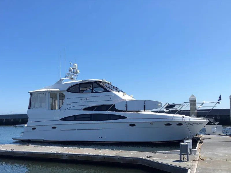 Slide: The Image of 2001 Carver 506 Motor Yacht docked under clear blue sky. - 10