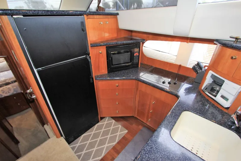Slide: The Image of Carver 506 Motor Yacht 2001 kitchen with microwave and refrigerator. - 18