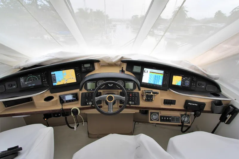 Slide: The Image of 2001 Carver 506 Motor Yacht cockpit with modern navigation displays. - 44