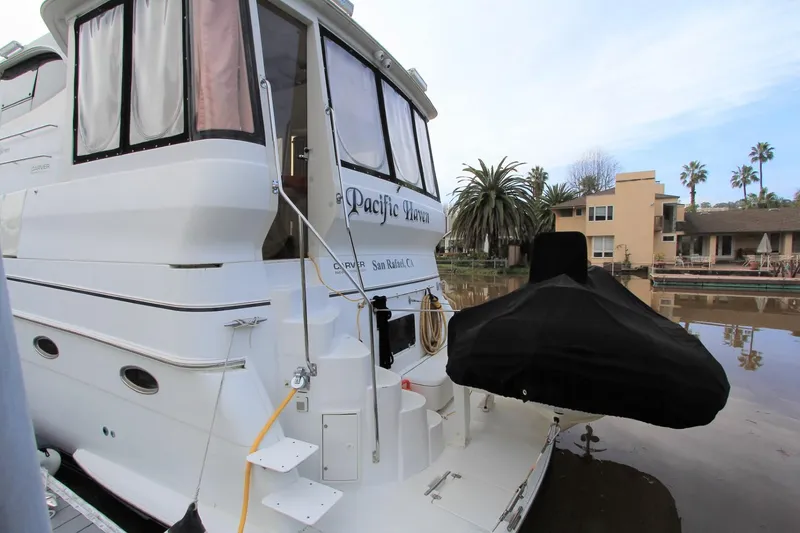 Slide: The Image of 2001 Carver 506 Motor Yacht docked with cover. - 7