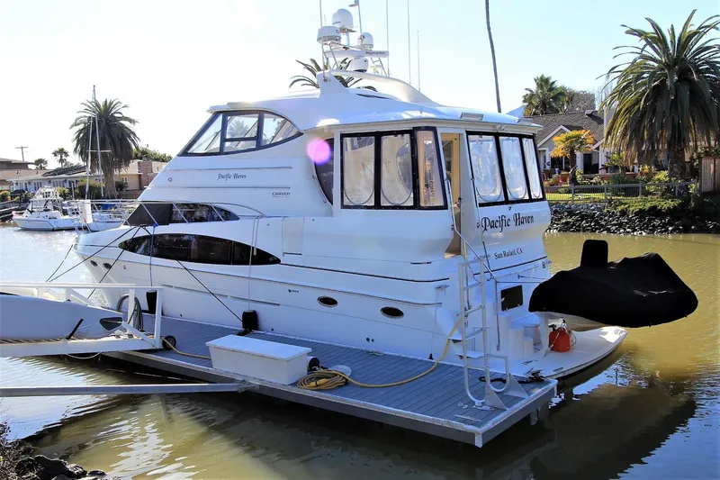 Slide: The Image of 2001 Carver 506 Motor Yacht docked on a sunny day. - 9