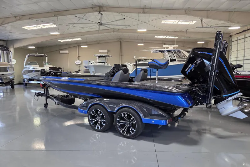 Slide: The Image of 2023 Caymas CX 20 boat in showroom, featuring sleek design and powerful engine. - 3