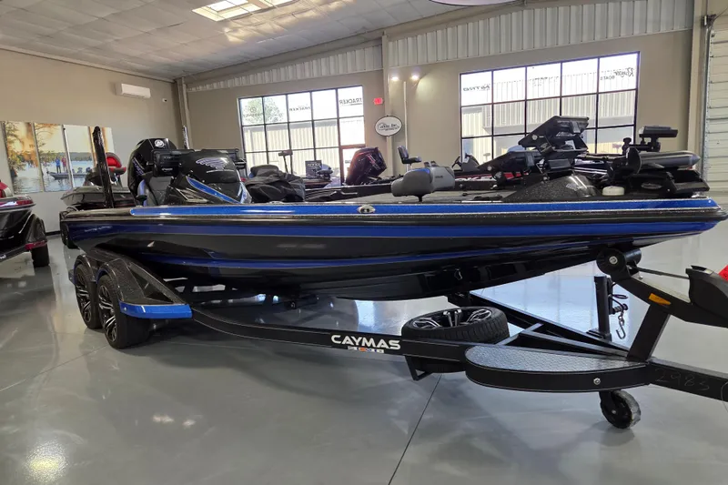 Slide: The Image of 2023 Caymas CX 20 boat in showroom, sleek design, blue and black color scheme. - 5