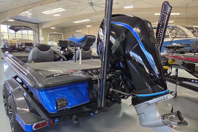 Slide: The Image of 2023 Caymas CX 20 boat with powerful outboard motor in showroom setting. - 6