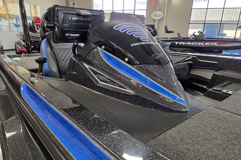 Slide: The Image of 2023 Caymas CX 20 boat interior with blue accents and advanced electronics. - 8