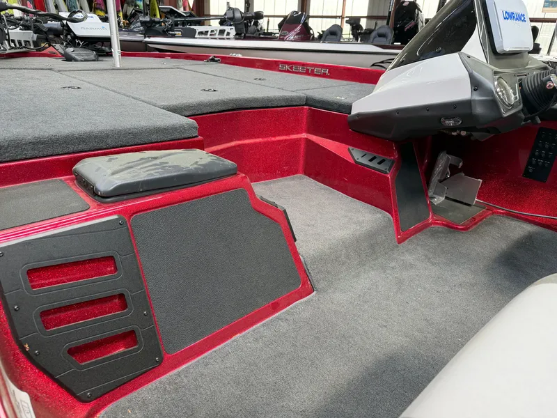 Slide: The Image of Interior of a 2016 Skeeter ZX225 boat with gray carpeting. - 10