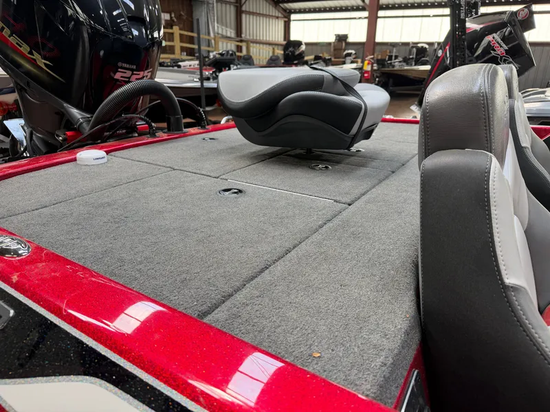 Slide: The Image of 2016 Skeeter ZX225 boat with Yamaha 225 engine in indoor setting. - 13