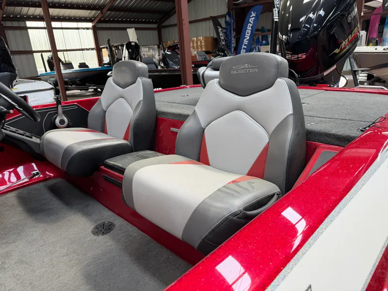 Slide: The Image of Interior of a 2016 Skeeter ZX225 boat with gray and red seats. - 9