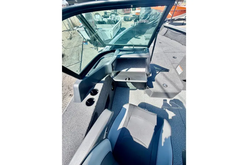 Slide: The Image of 2026 Lund 2075 Impact XS boat interior with seating and storage compartments. - 12