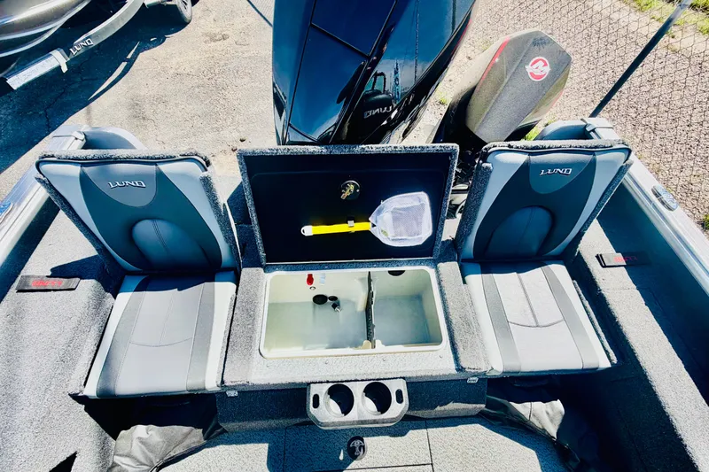 Slide: The Image of 2026 Lund 2075 Impact XS boat interior with seating and storage compartments. - 13