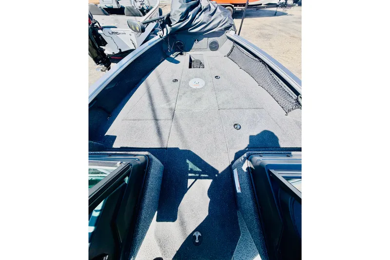 Slide: The Image of 2026 Lund 2075 Impact XS boat interior with spacious deck and storage compartments. - 14