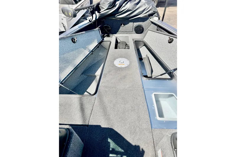 Slide: The Image of 2026 Lund 2075 Impact XS boat interior with storage compartments and seating. - 16