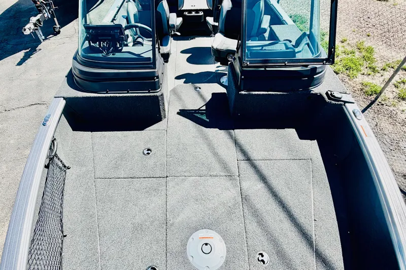 Slide: The Image of 2026 Lund 2075 Impact XS boat interior with seating and steering console. - 17