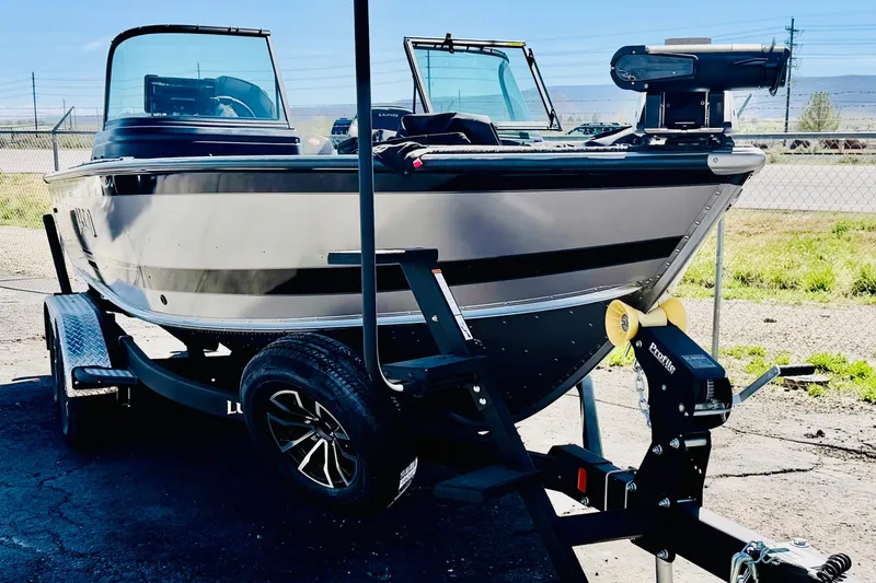 Slide: The Image of 2026 Lund 2075 Impact XS boat on trailer, parked outdoors in sunlight. - 3