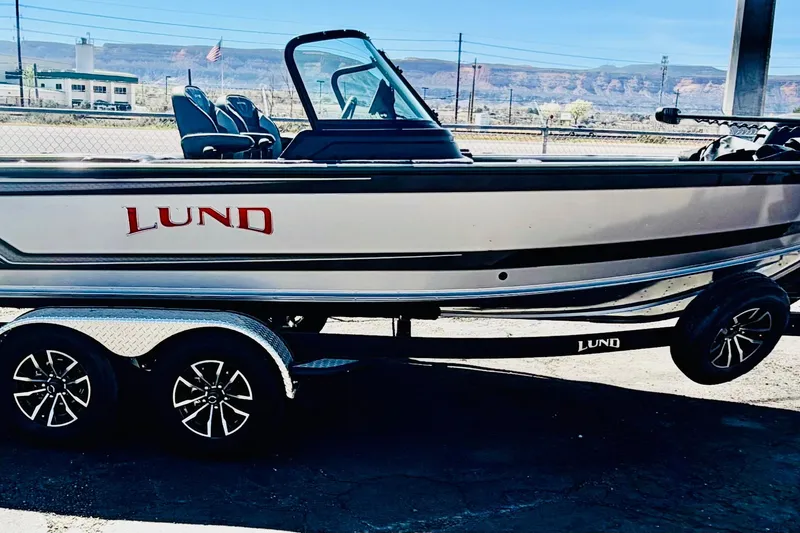 Slide: The Image of 2026 Lund 2075 Impact XS boat on trailer, parked outdoors. - 4