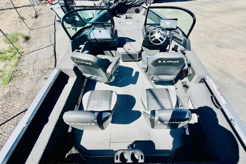 Slide: The Image of 2026 Lund 2075 Impact XS boat interior with seating and steering console. - 8