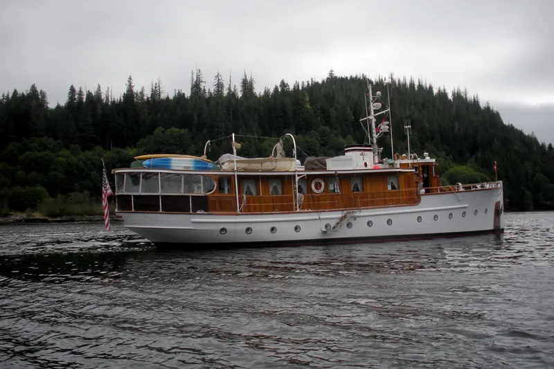 Slide: The Image of 1929 Custom HOFFAR-BEECHING Fantail Yacht cruising on a lake with forested hills in the background. - 16