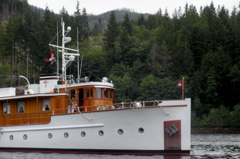 Slide: The Image of 1929 HOFFAR-BEECHING Fantail Yacht cruising near a forested shoreline. - 17