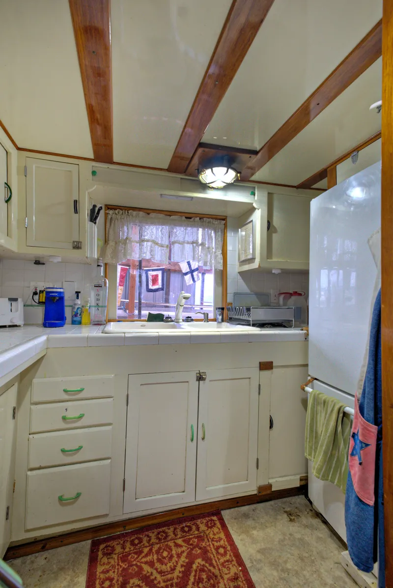 Slide: The Image of 1929 HOFFAR-BEECHING Fantail Yacht kitchen with vintage cabinets and modern appliances. - 45