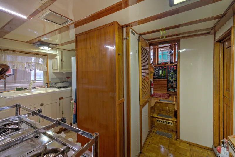 Slide: The Image of Interior of 1929 Custom HOFFAR-BEECHING Fantail Yacht with wooden cabinetry and kitchen area. - 48