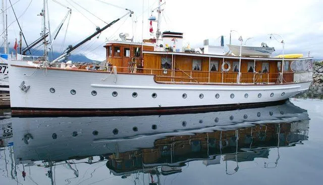 Slide: The Image of 1929 Custom HOFFAR-BEECHING Fantail Yacht docked, reflecting on calm water. - 6