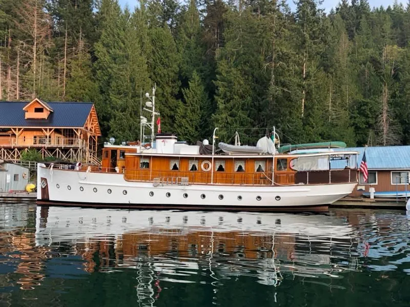 Slide: The Image of 1929 Custom HOFFAR-BEECHING Fantail Yacht docked by forested shoreline. - 8