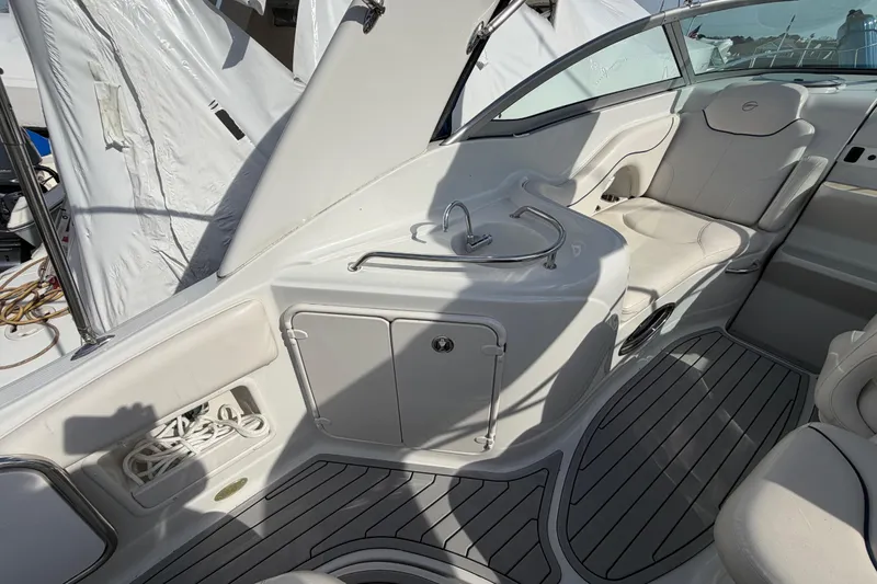 Slide: The Image of 2006 Crownline 270 CR boat interior with seating, sink, and storage compartments. - 10