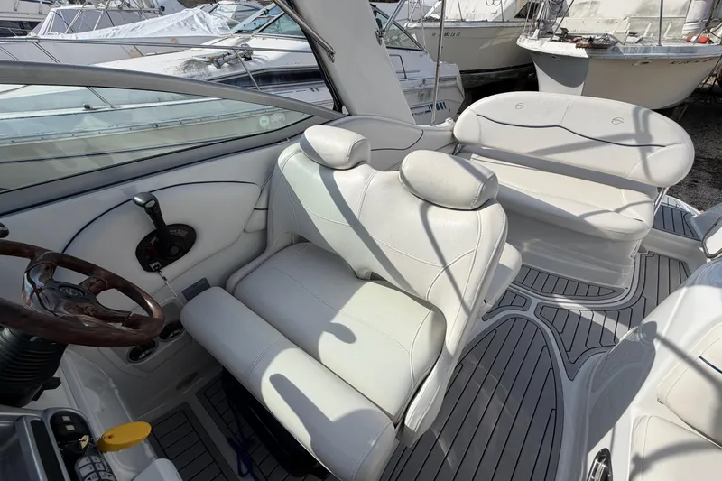 Slide: The Image of Interior of a 2006 Crownline 270 CR boat with white seating and steering wheel. - 12