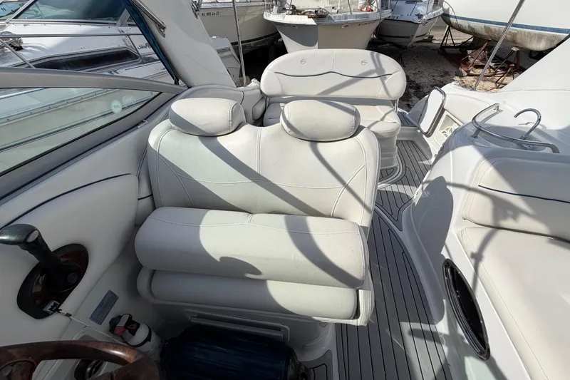 Slide: The Image of Interior of a 2006 Crownline 270 CR boat with white seating and steering wheel. - 13