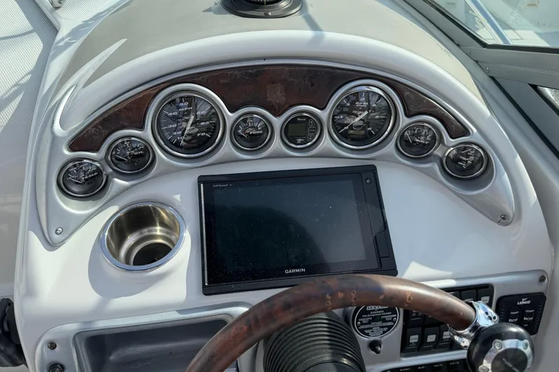 Slide: The Image of Dashboard of a 2006 Crownline 270 CR boat with gauges and Garmin display. - 15