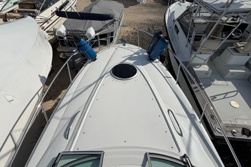 Slide: The Image of 2006 Crownline 270 CR boat deck view, surrounded by other boats in storage. - 16
