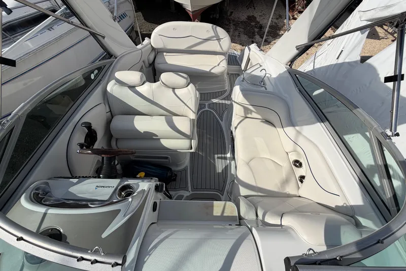 Slide: The Image of 2006 Crownline 270 CR boat interior with white seating and steering console. - 17
