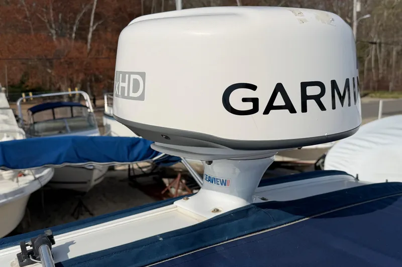 Slide: The Image of Garmin radar on 2006 Crownline 270 CR boat, docked with other vessels in background. - 18