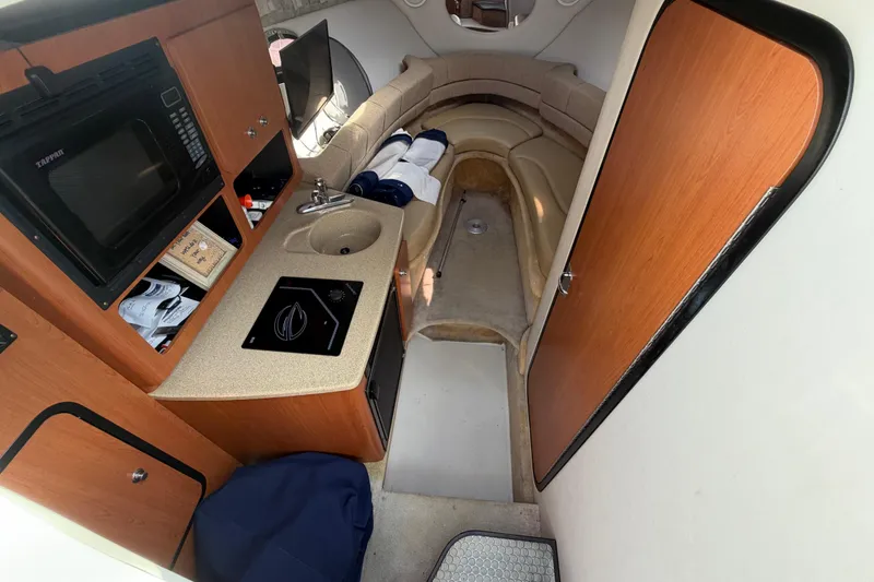 Slide: The Image of Interior of 2006 Crownline 270 CR boat with kitchenette and seating area. - 19
