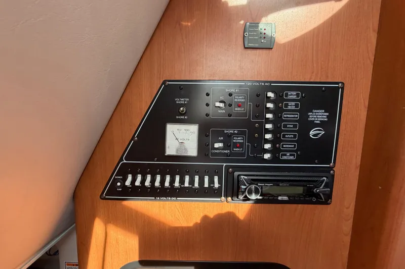 Slide: The Image of Control panel of a 2006 Crownline 270 CR boat, featuring various switches and a voltmeter. - 21