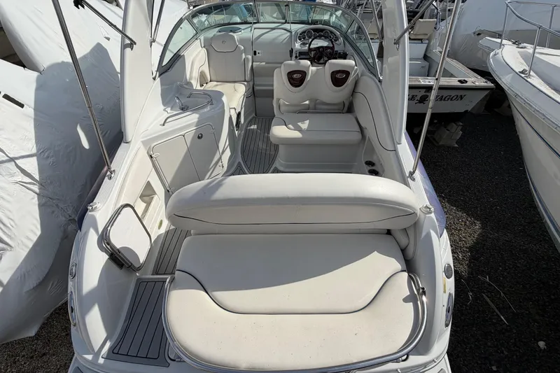 Slide: The Image of 2006 Crownline 270 CR boat interior with white seating and steering console. - 6