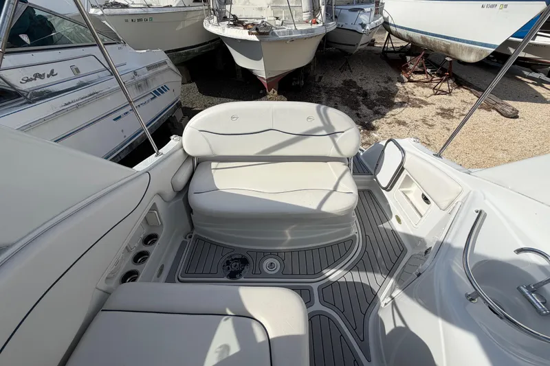 Slide: The Image of 2006 Crownline 270 CR boat interior with white seating and deck details. - 8