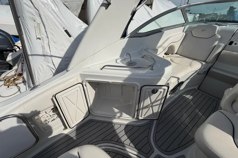 Slide: The Image of 2006 Crownline 270 CR boat interior with seating, sink, and storage compartments. - 9