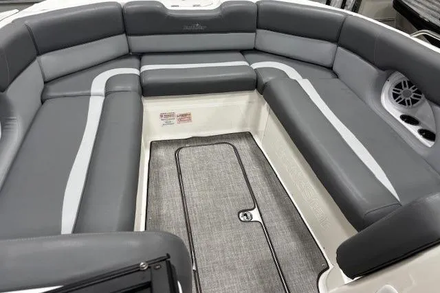 Slide: The Image of 2023 NauticStar 243DC Sport Deck interior with steering wheel and cushioned captain's chair. - 16