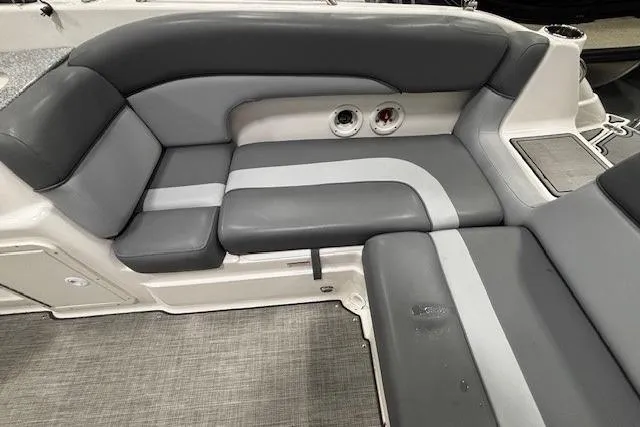 Slide: The Image of 2023 NauticStar 243DC Sport Deck boat with black cover, docked outdoors. - 17