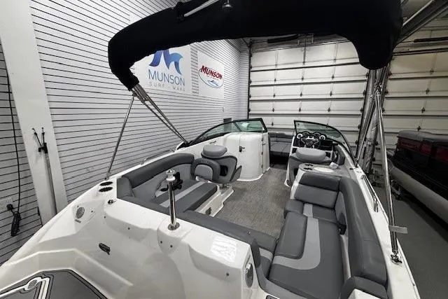 Slide: The Image of 2023 NauticStar 243DC Sport Deck boat interior with gray seating and carpeted floor. - 19