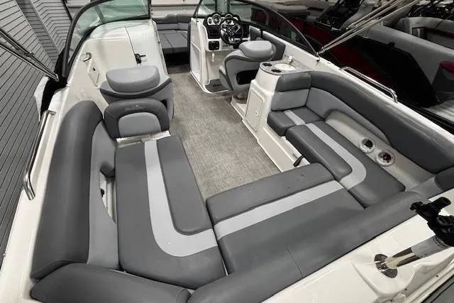 Slide: The Image of 2023 NauticStar 243DC Sport Deck boat in showroom with protective cover. - 26