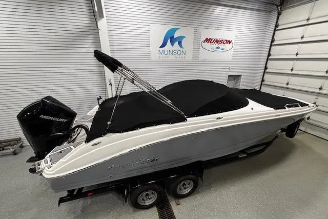 Slide: The Image of 2023 NauticStar 243DC Sport Deck boat on trailer in showroom. - 27