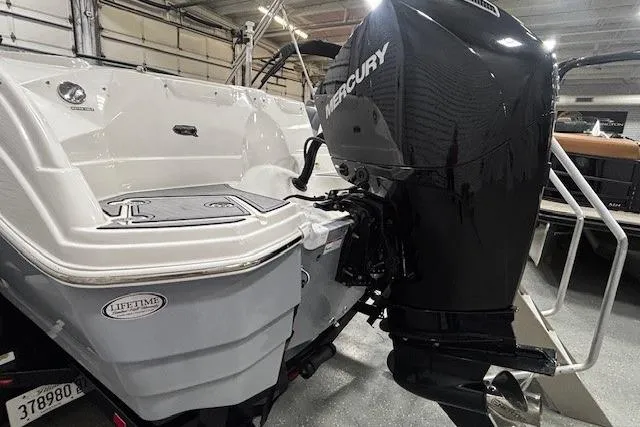 Slide: The Image of 2023 NauticStar 243DC Sport Deck boat in showroom, covered and on trailer. - 33