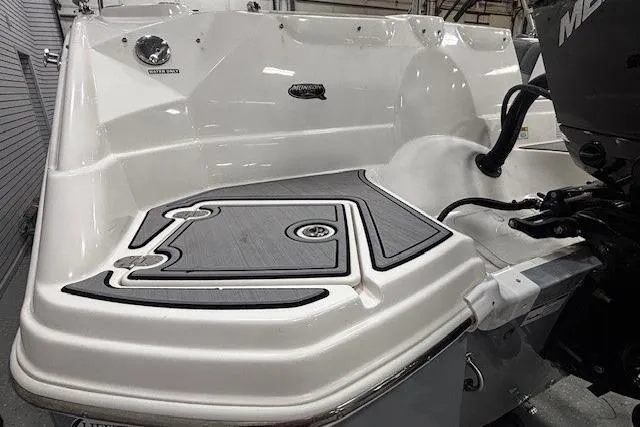 Slide: The Image of 2023 NauticStar 243DC Sport Deck boat interior with gray cushioned seating and integrated speakers. - 34