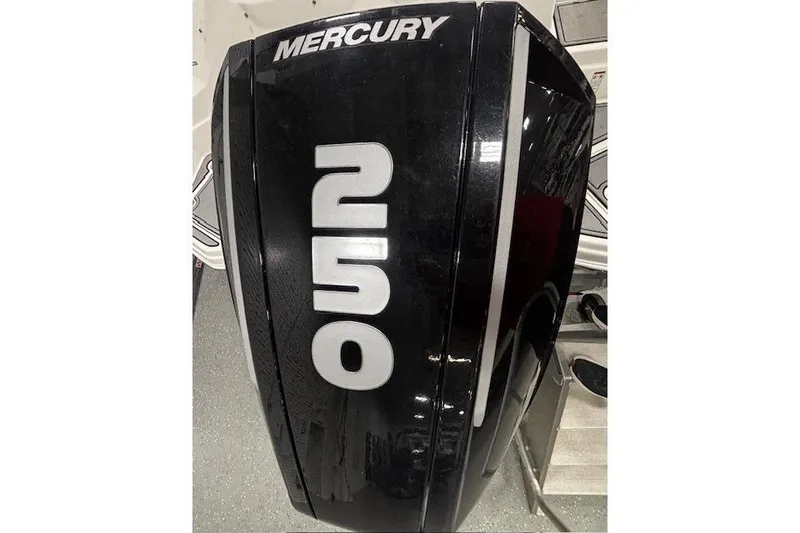 Slide: The Image of 2023 NauticStar 243DC Sport Deck boat in showroom, covered and on trailer. - 36