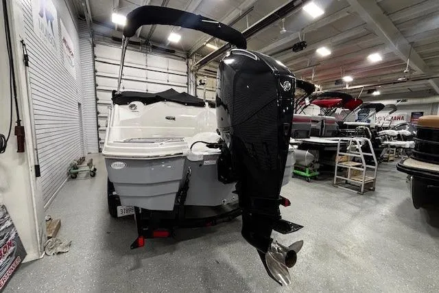 Slide: The Image of 2023 NauticStar 243DC Sport Deck boat with Mercury outboard engine in a showroom. - 38